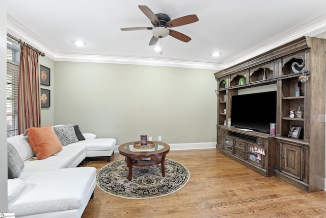 living room with crown molding, light hardwood / wood-style flooring, and ceiling fan