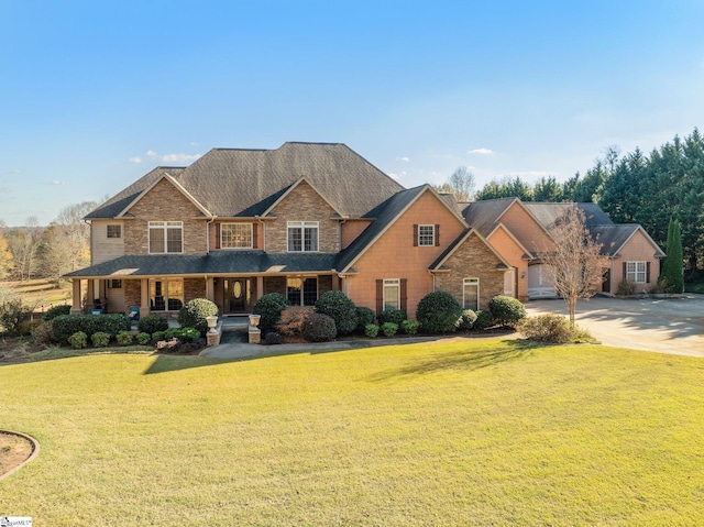 craftsman-style house featuring covered porch and a front yard