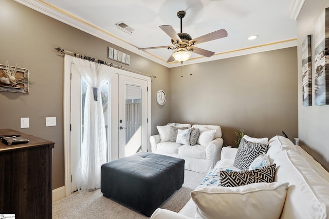 carpeted living room featuring ceiling fan, french doors, and ornamental molding