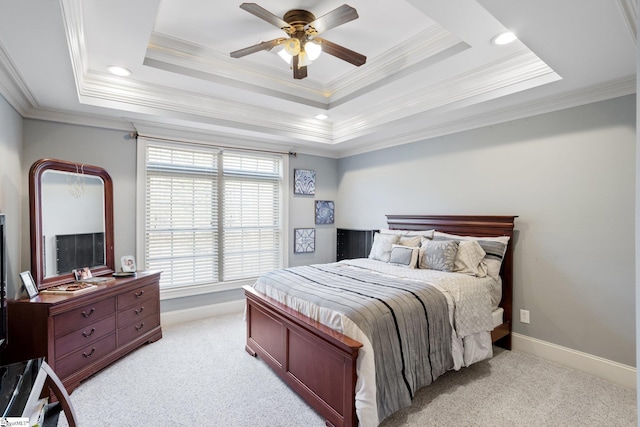 bedroom featuring a raised ceiling, crown molding, ceiling fan, and light colored carpet