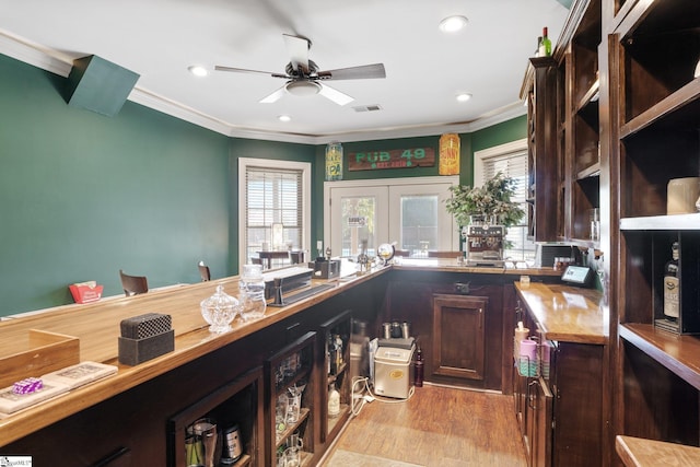 kitchen with french doors, dark brown cabinetry, ceiling fan, crown molding, and light hardwood / wood-style floors