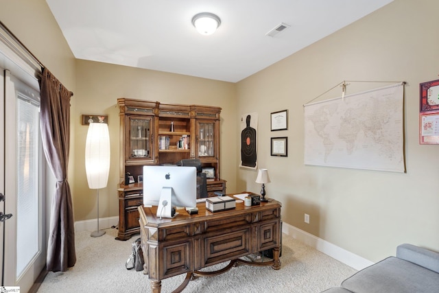 office area featuring light carpet