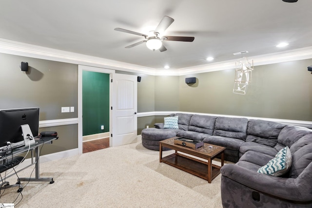 carpeted living room with ceiling fan and ornamental molding