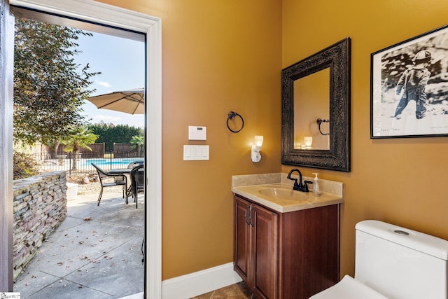 bathroom featuring tile patterned flooring, vanity, and toilet