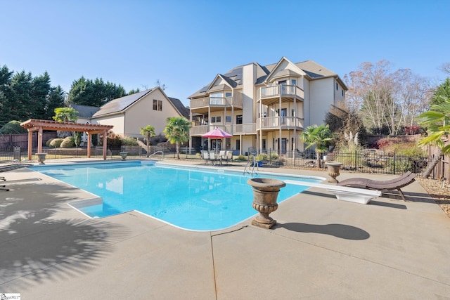 view of pool with a pergola and a patio