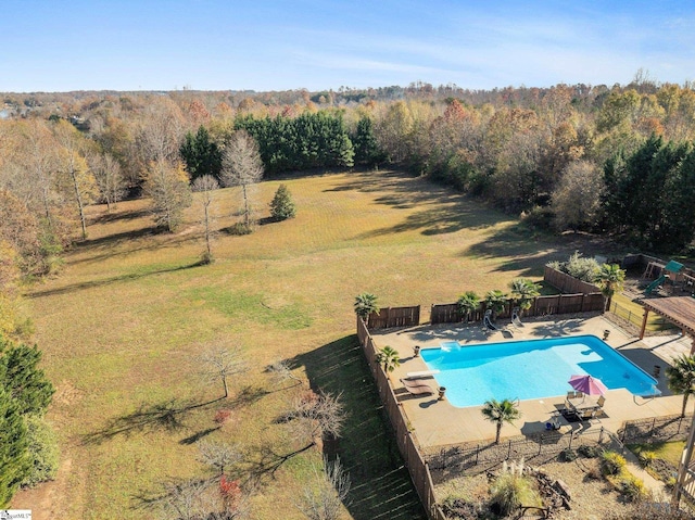 view of pool with a diving board, a yard, and a patio