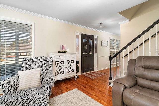 living room featuring wood-type flooring and ornamental molding