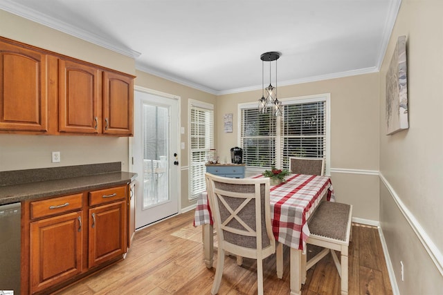 dining room featuring crown molding, light hardwood / wood-style floors, and a notable chandelier