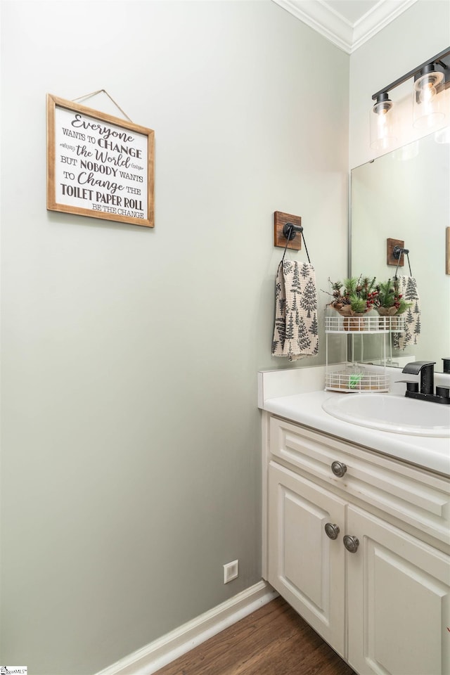 bathroom featuring hardwood / wood-style floors, vanity, and crown molding