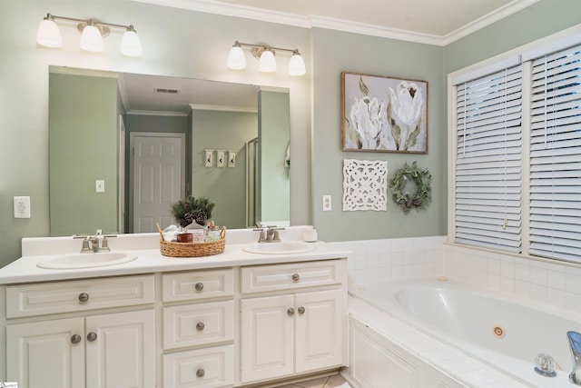 bathroom with vanity, crown molding, and tiled bath