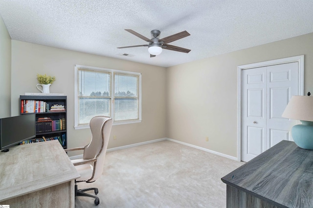 carpeted office with ceiling fan and a textured ceiling