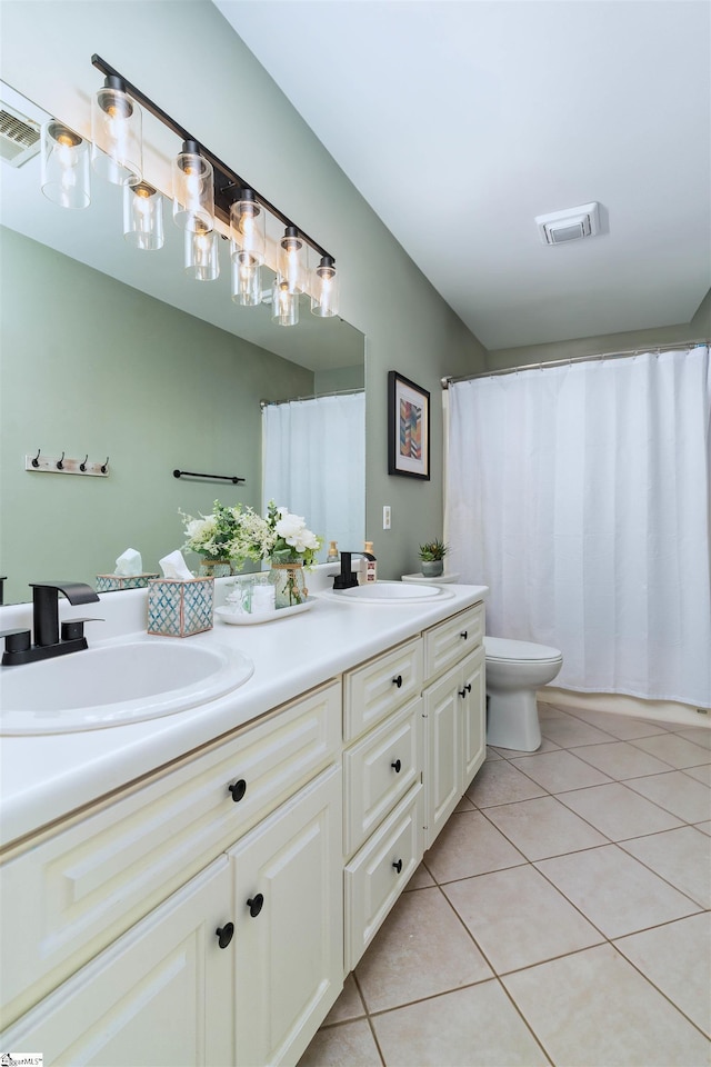 bathroom with tile patterned flooring, vanity, and toilet