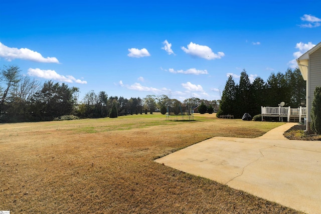 view of yard with a patio area and a trampoline