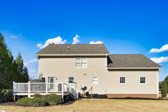 back of house featuring cooling unit, a deck, and a yard