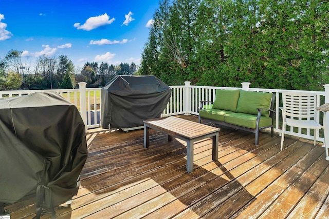 deck with an outdoor living space and a grill