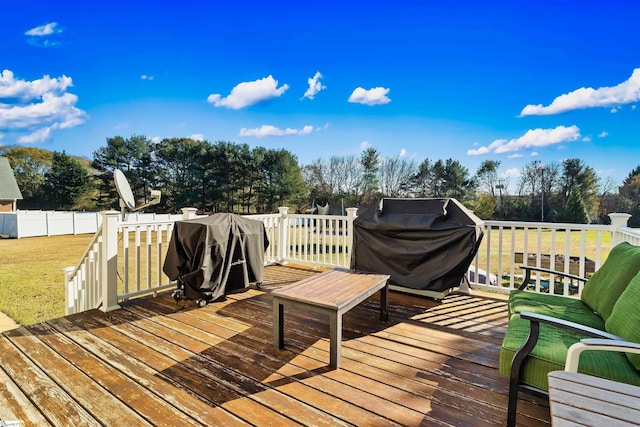 wooden deck with a lawn and a grill