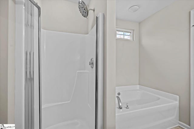 bathroom with separate shower and tub