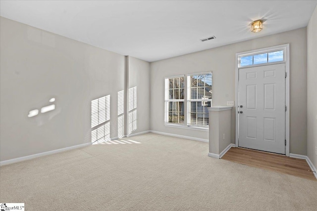 entryway featuring light carpet