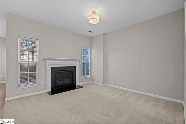 unfurnished living room with light carpet