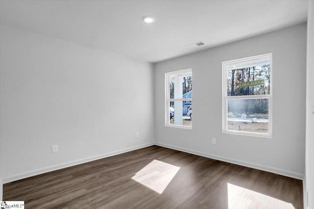 empty room featuring dark wood-type flooring