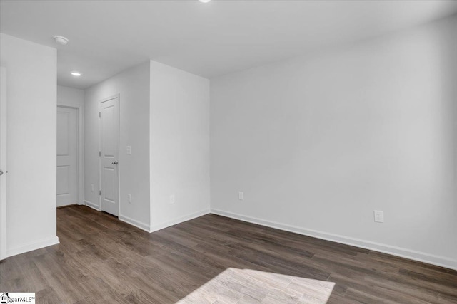 unfurnished room with dark hardwood / wood-style floors