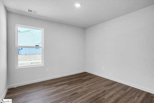 unfurnished room with a wealth of natural light and dark wood-type flooring