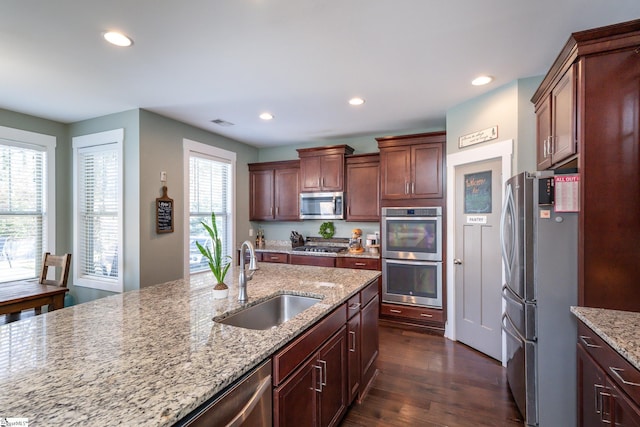 kitchen with sink, dark hardwood / wood-style floors, plenty of natural light, and appliances with stainless steel finishes