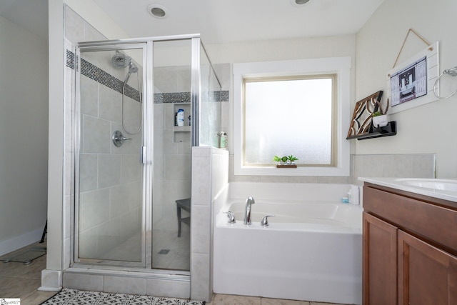 bathroom with tile patterned floors, vanity, and plus walk in shower