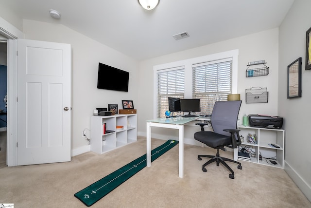 carpeted home office with lofted ceiling