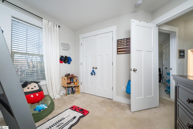 carpeted bedroom with multiple windows and a closet