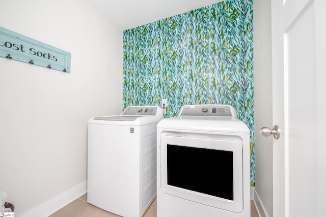 laundry area with light tile patterned floors and washer and dryer