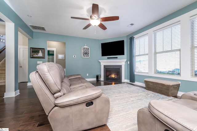 living room with dark hardwood / wood-style floors and ceiling fan