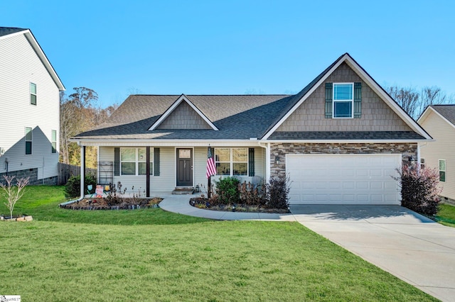 view of front of house with a front yard, a garage, and covered porch