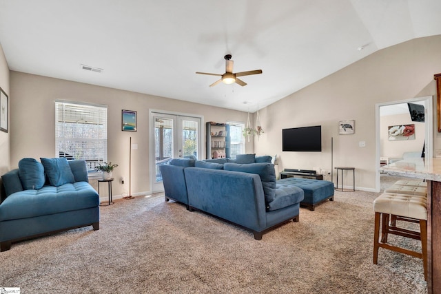 carpeted living room featuring vaulted ceiling and ceiling fan