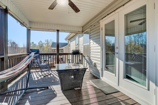 wooden deck featuring french doors and ceiling fan