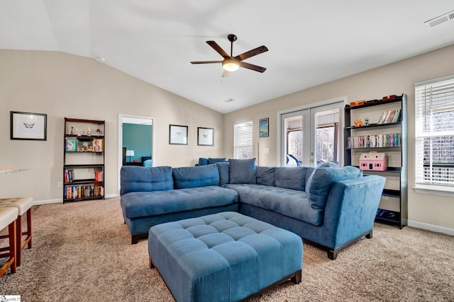 living room with a wealth of natural light, light carpet, and vaulted ceiling