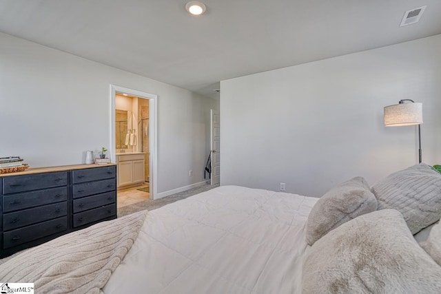 carpeted bedroom with ensuite bath