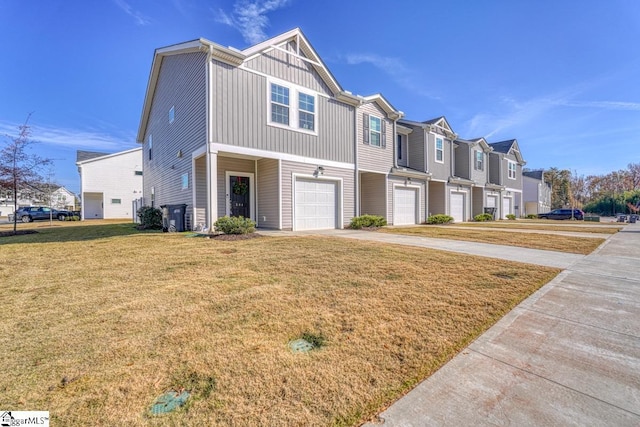 view of property with a front yard and a garage