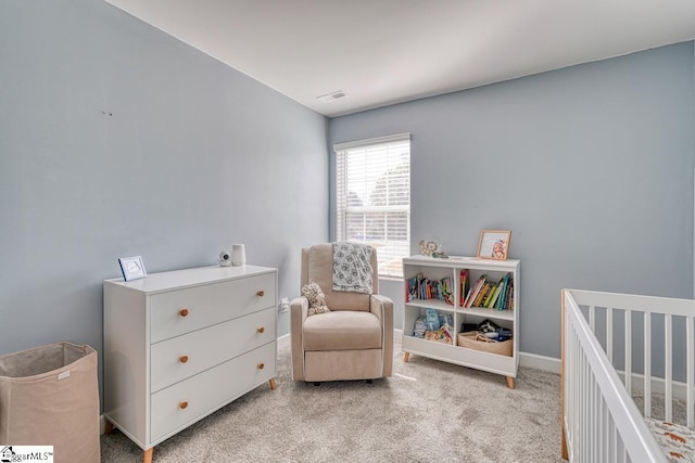 bedroom with a crib and light carpet