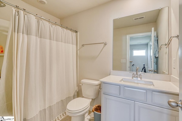 bathroom with vanity, a shower with shower curtain, and toilet