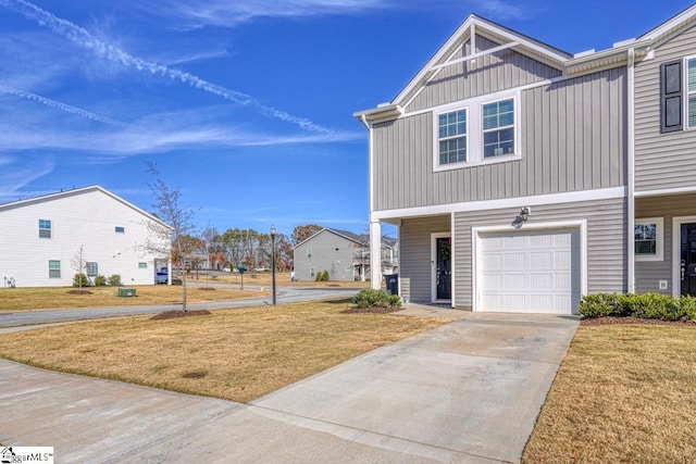 view of front of home with a garage and a front lawn