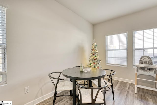 dining area with hardwood / wood-style floors