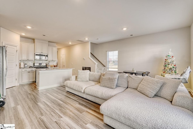 living room with light hardwood / wood-style flooring