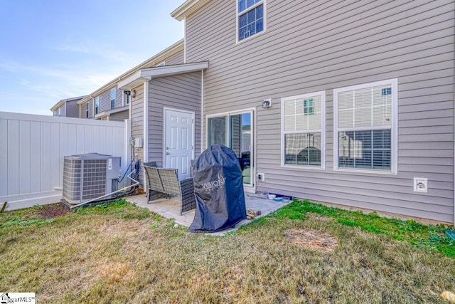 rear view of house with a yard and cooling unit