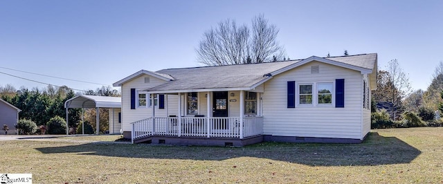 view of front of house featuring a carport, covered porch, and a front yard