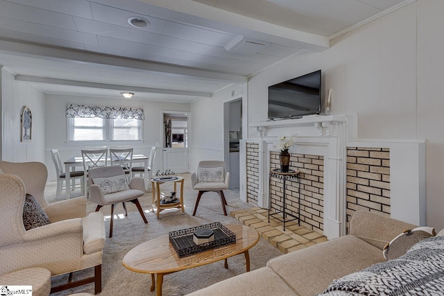 carpeted living room with beam ceiling and ornamental molding