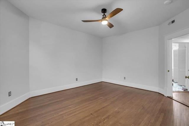 spare room with ceiling fan and wood-type flooring