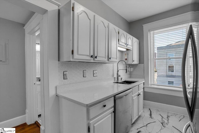 kitchen featuring dishwasher, white cabinets, sink, tasteful backsplash, and fridge