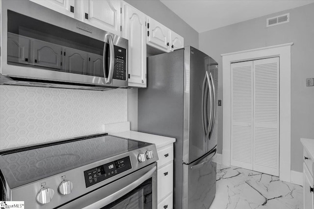 kitchen featuring white cabinets and appliances with stainless steel finishes