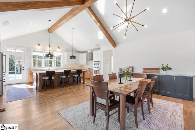 dining area featuring beam ceiling, sink, high vaulted ceiling, a chandelier, and light wood-type flooring